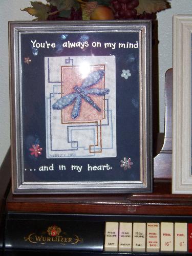 Cross stitch pictue that I made for my twin sister - I did the counted cross stitch picture, I then matted it and added the lettering and flowers to the matting and framed it. 