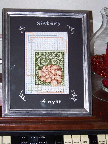Cross stitch picture I made for my sister - I framed the picture and added the lettering and filigree.