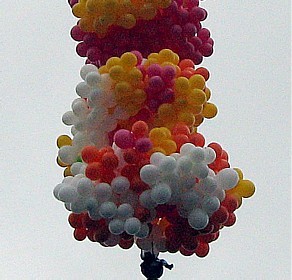 When the priest took off - The Rev. Adelir Antoio de Carli lifts off Sunday under hundreads of helium party balloons.