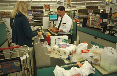 Cashier/Checkout - Working in a supermarket as a cashier.