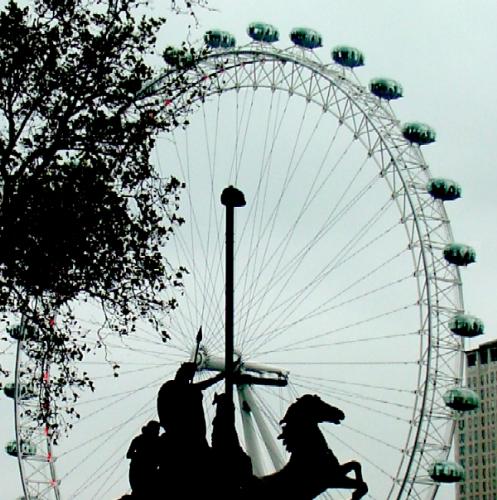 the London Eye - The statue of Queen Boadicea silhouetted against the London Eye - London UK the London Eye - The statue of Queen Boadicea silhouetted against the London Eye - London UK