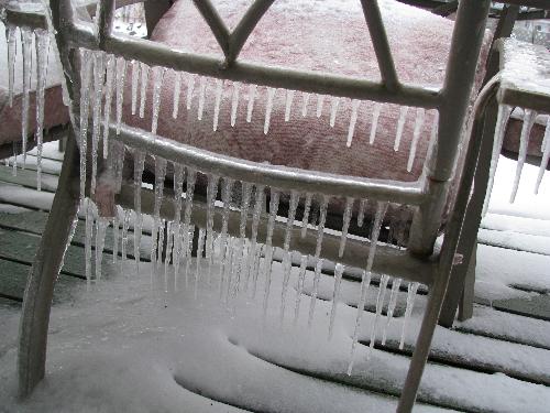 Icicles hanging from 'summer' deck chairs - This photo was taken from our deck after a winter storm in Manitoba on April 24th. They are a common part of winter...but not usually present in 'Spring.'