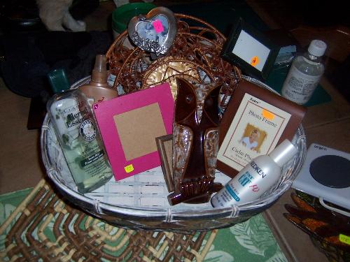 Bountiful basket of thrift store 'finds' - I love thrift store shopping. This basket of gently used items still has the price tags on them. 20 cents for a pewter frame...how much would that cost new? The hot plate to set my teapot on...one whole dollar...and yes, it works! Love thrift stores!