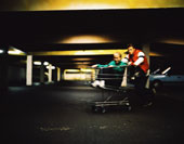 two teens playing with shopping cart - Two teens playing with shopping cart in a parking garage