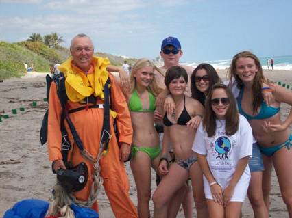 Skydiver and JMST treehuggers - During the Kite Beach to Corners cleanup a skydiver serinated the Jupiter Middle School Treehuggers. What a great surprise, and a great time.
