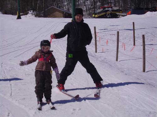 skiing time - my daughter skiing with her grandfather