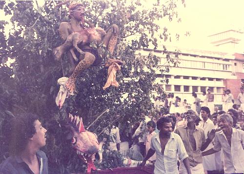 Cat-Man - Clicked during Onam celebrations in Trichur, Kerala, India sometime in 1988/89. It is not a clay model but a live person dressed like a leopard. He is feasting on a goat and has its intestine in his mouth. Notice the expression of the person on the bottom right hand corner of the picture.