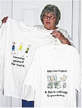 Me and my shirts - Here I am holding one of my own designed t shirts.