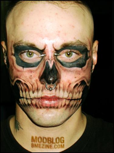 extreme body modifications - Face tats and piercings on young guy.