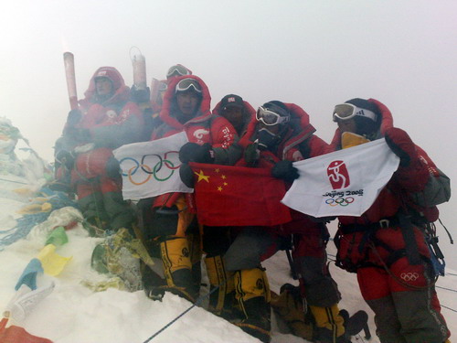 Beijing Torch Relay has finally arrived at Mount Q - 2008 Beijing Olympic Torch has finally arrived at the peak of Mount Qumolangma. The team is showing the Torch, The Olympic Flag, The PRC's national flag and the Beijing 2008 Olympic Flag