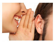 Whispering secrets of a happy life. - A picture of a secret being told.