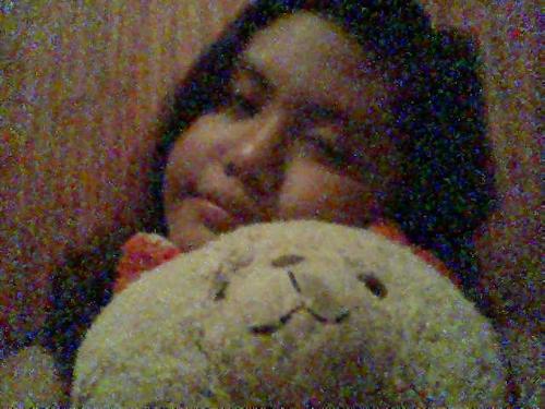 Sleeping - Girl sleeping while hugging her old white teddy bear.