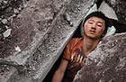 disaster victim - a kid under debris in SW China, being give transfusion and waiting to be pulled out