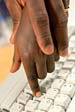 computer kid - This is a cute pic of a parent who seems to be helping a child do something on a keyboard. I think it's very endearing!