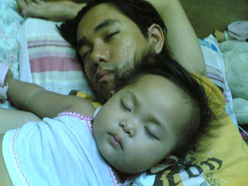 my daughter and his daddy -  my 1 year old daughter,she love to sleep in top even me or his father. she love to hand her feet also in the wall while shes sleep,