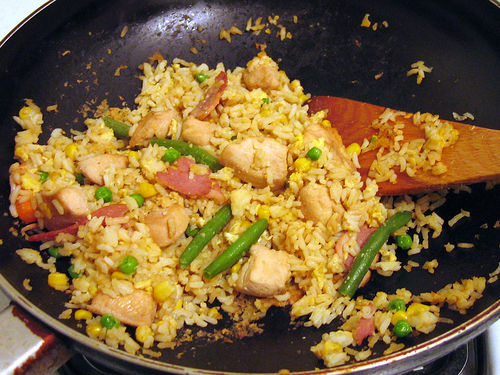 Do you prefer home-cooked food or outside food? - A picture of a wok full of fried rice. Photo source: http://farm1.static.flickr.com/1/2218353_c5f47793ab.jpg?v=0 .