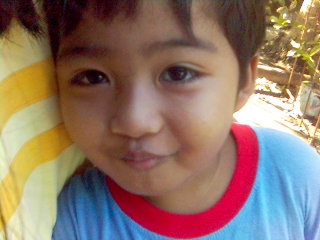 my cousin Mark Vincent! :) - This photo was taken about 2-3 years or so (?) ago while we were having our vacation in my father's hometown - Tarlac City. As you can see, this cute little cuddly boy is one of my cousins, and the first one to have acquired the heir of the Facun Family since he is the first grandson of my lola, bearing the family surname. He is always such a cute guy, and very lovable, and huggable that's why I always look forward to seeing him soon! :) I think he's by now 5 years of age..