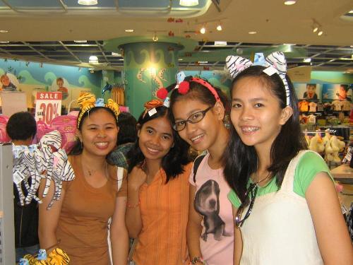 My high school friends and I - Last year, about October 2006, my friends and I have decided to take an exam in one of the most prominent universities here in our country, the University of Sto. Tomas. Consequently, since we already are far from home and had a service in which we can stroll around the national city, we headed to Mall of Asia, currently the third largest mall in the world(?), and we found ourselves having fun with the merchandises it offers. :) The one you see here in this photo is the Animal-printed hair bands. :)
