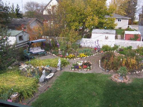 Fall photo of our back garden - This photo was taken from our upper screened in deck in Fall of last year. My hubby and I landscaped the whole yard ourselves and gathered the rocks from the side of the road. Lots of hard work...but our backyard and deck become our outdoor living room...and we love to sit by the pond around our campfire on warm summer evenings.