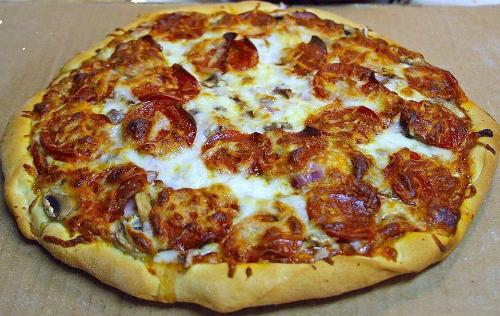 Pepperoni Pizza - A pepperoni pizza that has been cooked in an oven.