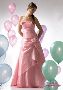 Graduation Gowns - Young teen in ball gown intended for prom night.  Pink gown, with shiffon adornments and rose to highlight. Balloon in scenery acts as a decoration showing the reason for the the gown which is obviously, the prom; what every girl looks forward to as a teenager.