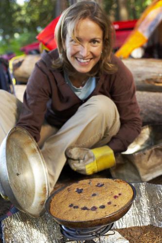 Smiley in a Cake - This is a picture of a woman who has baked a cake. She added a few cherries on top to make a smiley face. Or would that be an emoticon? It looks very cheerful and tasty too.