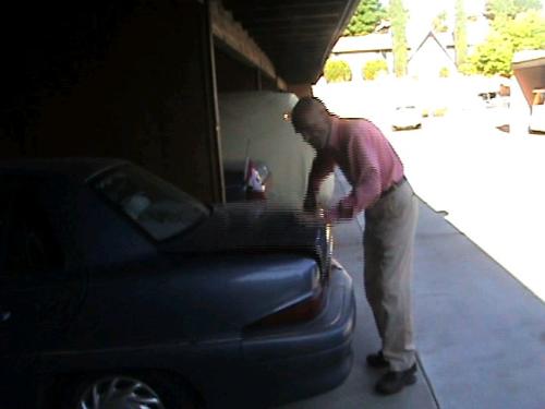 Loading Luggage - My husband is attempting to fit all of my luggage into the trunk of our car.