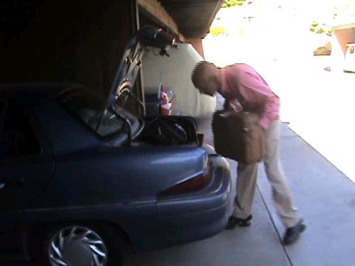 I gues not!  - He realizes it's not going to fit, and decided to move one of my suitcases to the back seat of the car instead.