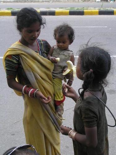 beggars - A picture showing a women with her kid begging
