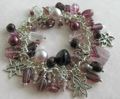 Passion for Purple Bracelet - This 7 1/2' silver plated bracelet is loaded with glass beads in gorgeous variations of purples. Three silver flower charms accent these beautiful beads on this cha-cha style bracelet. Great for those with a passion for purple!
