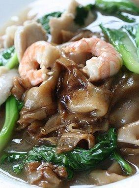 Char Hor Fun - A broad noodle dish with a starchy sauce. Usually stir fried with seafood and vegetables. 

There are a few varieties of it. Some like it with dark soy sauce and meat. Others like it with light soy sauce and fish. 

All of them are nice!