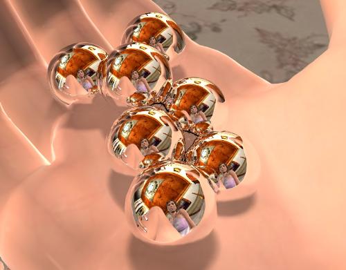 Reflections - A cool render of some marbles in a woman's hand.