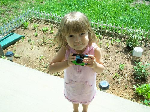 My youngest taking pictures. - My youngest is outside with me, taking pictures, as I'm taking pictures of the outside of our home.