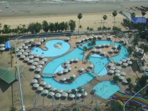 bird's eyeview - I was on the 56th floor of Pattaya tower when I took this photo. It was so far that I cannot even see the people down below. The picture just looks like a toy but it is so real. That is the pool inside Pattaya park,that is close to the beach too!
