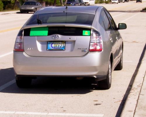 Toyota Prius Hybrid with Green License Plate - A silver Toyota Prius Hybrid with the Environmental Green License Plate. The license plate is made from 100% recycled plastic milk jugs in Garfield Minnesota. EarthRehab retails the Green License Plate for $10 online with proceeds to benefit the most productive Environmental non profit Foundations and Sanctuaries. See who is involved at EarthRehab.com