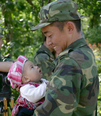 a Chinese soldier and a baby - The man is a Chinese soldier,he went to help people,he saved a baby,but the baby's mother died.