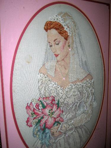 Cross stitch - A finished cross stitch project of a bride dressed in white attached with beads, crystals and flowers stitched by me.