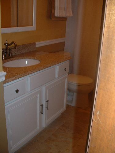 Bathroom - Freshly painted cabinet under the sink, with new hardware