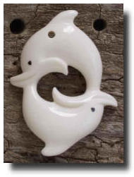 2 Dolphins 'Nose to Tail ' Bone Carving - Two dolphins together lovingly carved in (cow) bone by the Native New Zealand Maori carvers into these wonderful pendants.
