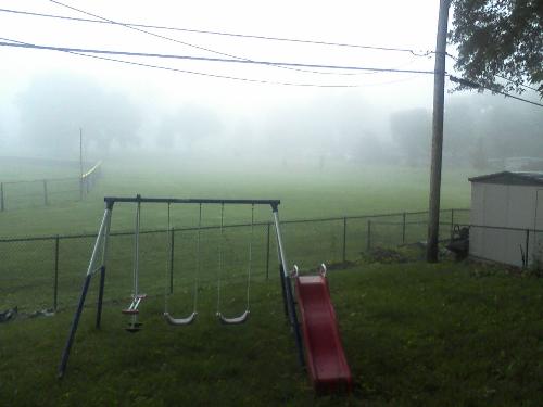On a moody Misty Morning - A picture of my daughter's swing on a foggy morning.