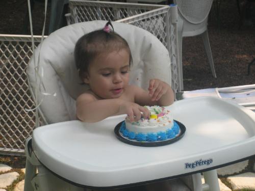 My granddaughter's first birthday - Here she is at her party with her OWN cake!! Mommy has her just in a diaper as she know she will be wearing it!! LOL