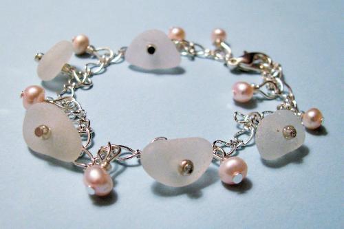 Frosty white sea glass bracelet - Five frosty white pieces of sea glass adorn this 7 1/2' bracelet. Pretty pale pink fresh water pearls accent the sea glass pieces.