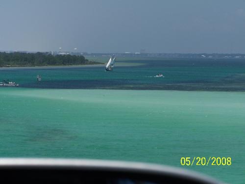 Beautiful Destin Fl - Beautiful post card perfect water in Destin Fl. We crossed over a bridge and all oohhed and awwwed as the water came into veiw. We saw five dolphins swimming in the water below us. that is how crystal clear the water was. It was so amazing.