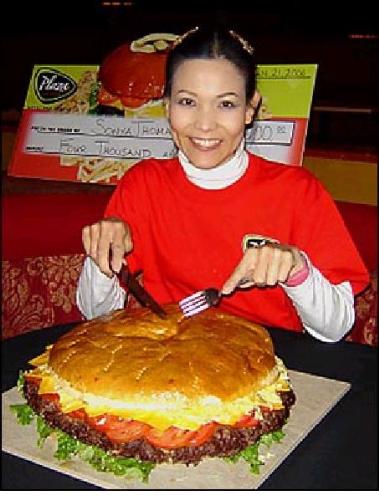 Talk about a big bite - A HUGE HAMBURGER. LOL, nothing more to it. She looks WAAAY to skinny to eat that
