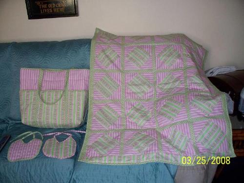 babies things - This is my sons best freinds baby shower present. I made a matching baby blanket, 2 bibs and a diaper bag. I got the pattern for the diaper bag online and copied one of my grandsons bibs.