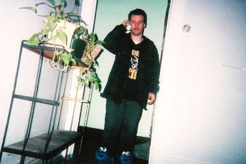 My hubby - Here is my husband wearing my cookie monster slippers that he got me for Christmas that year. His feet were cold, lol. :)