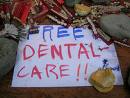 Do you see it happening? - Picture of sign painted with "Free Dental Care!!"