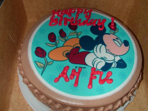 Birthday Cake - Chocolate cake with a sugar-based surface featuring Mickey Mouse.