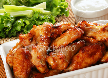 chicken - Big plat of chicken wings with blue cheese sauce, celery and lettuce.
