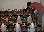 Battery Bank - This is our main battery bank for Eagle Plateau. It is configured to operate on a DC input of 24 Volts DC into a 2 Kw Heart Power Inverter providing us with a continuous 1240 Volts Ac supply for the main self sufficient home.  We use 24 units of 2 Volts Yuasa tubular type deep cycle lead acid storage batteries. On this photo you can see our handy man Sius dojng a routine maintenance topping up the batteries with distilled water.